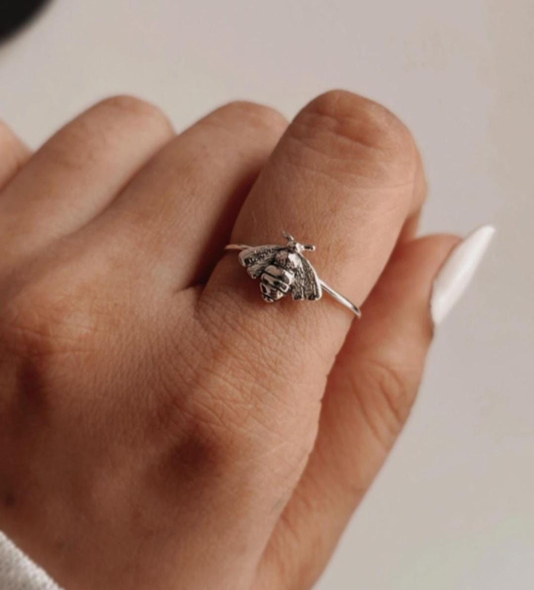 Statement silver ring featuring a large bee design.