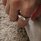 Close-up of clear quartz set in a classic signet silver ring