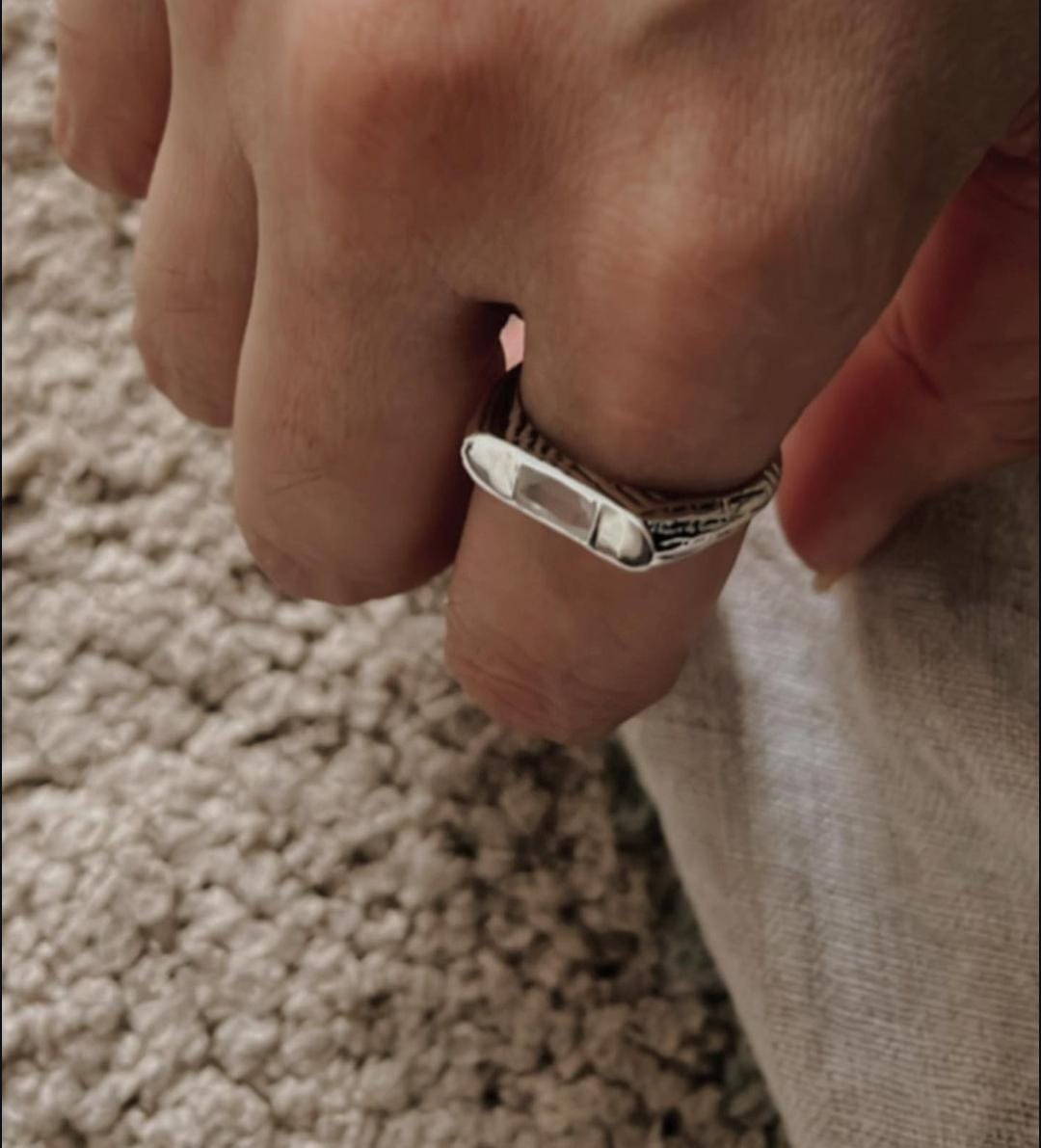 Close-up of clear quartz set in a classic signet silver ring