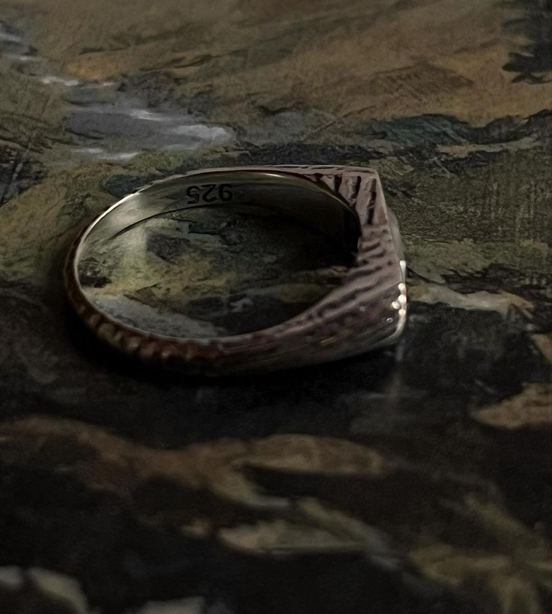 Sleek silver signet ring with round clear quartz stone