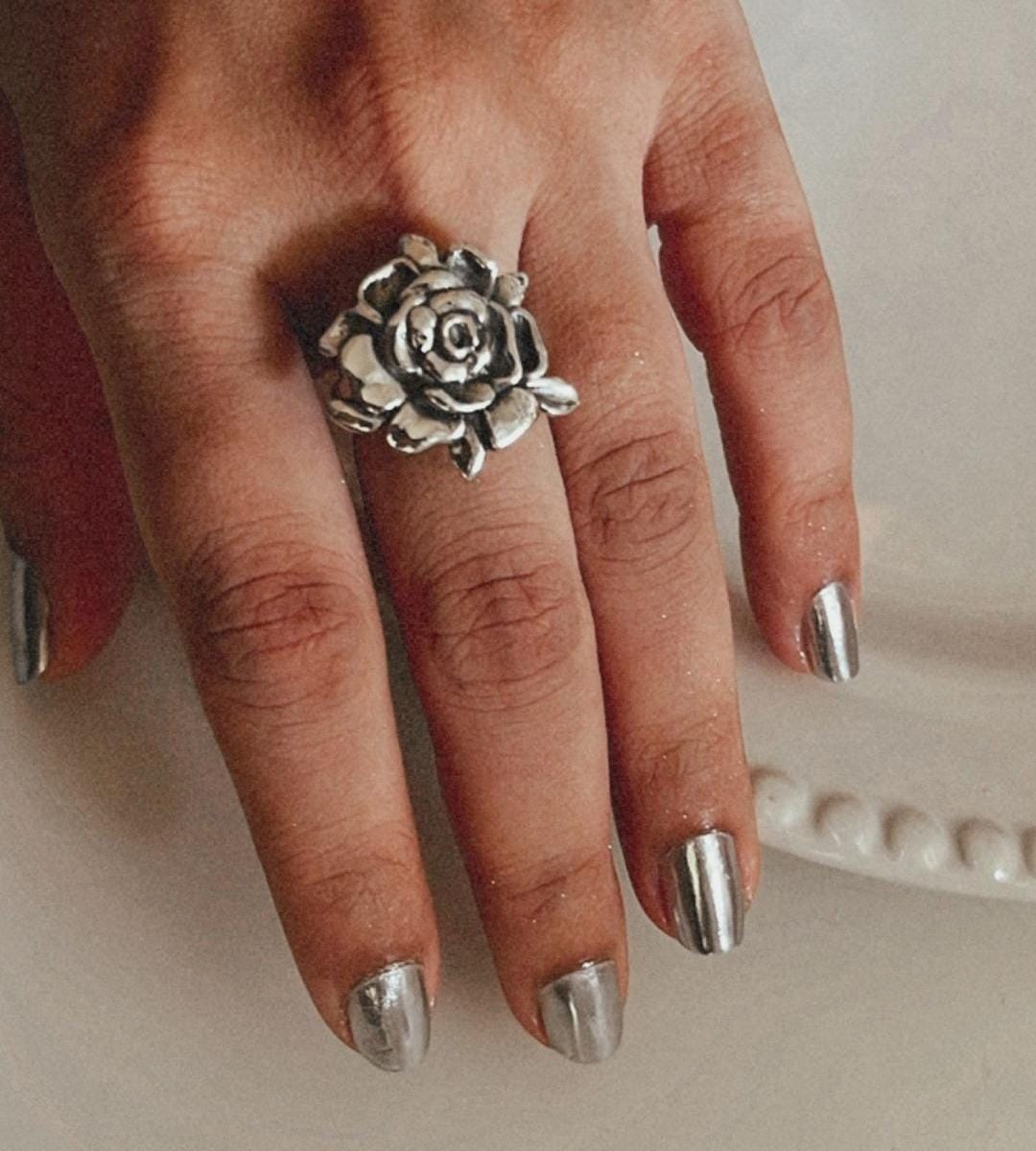 Elegant chunky silver ring with a detailed rose accent