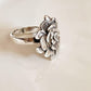 Bold silver ring with a chunky band and rose detailing