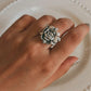 Chunky silver ring with a smooth finish and rose embellishment