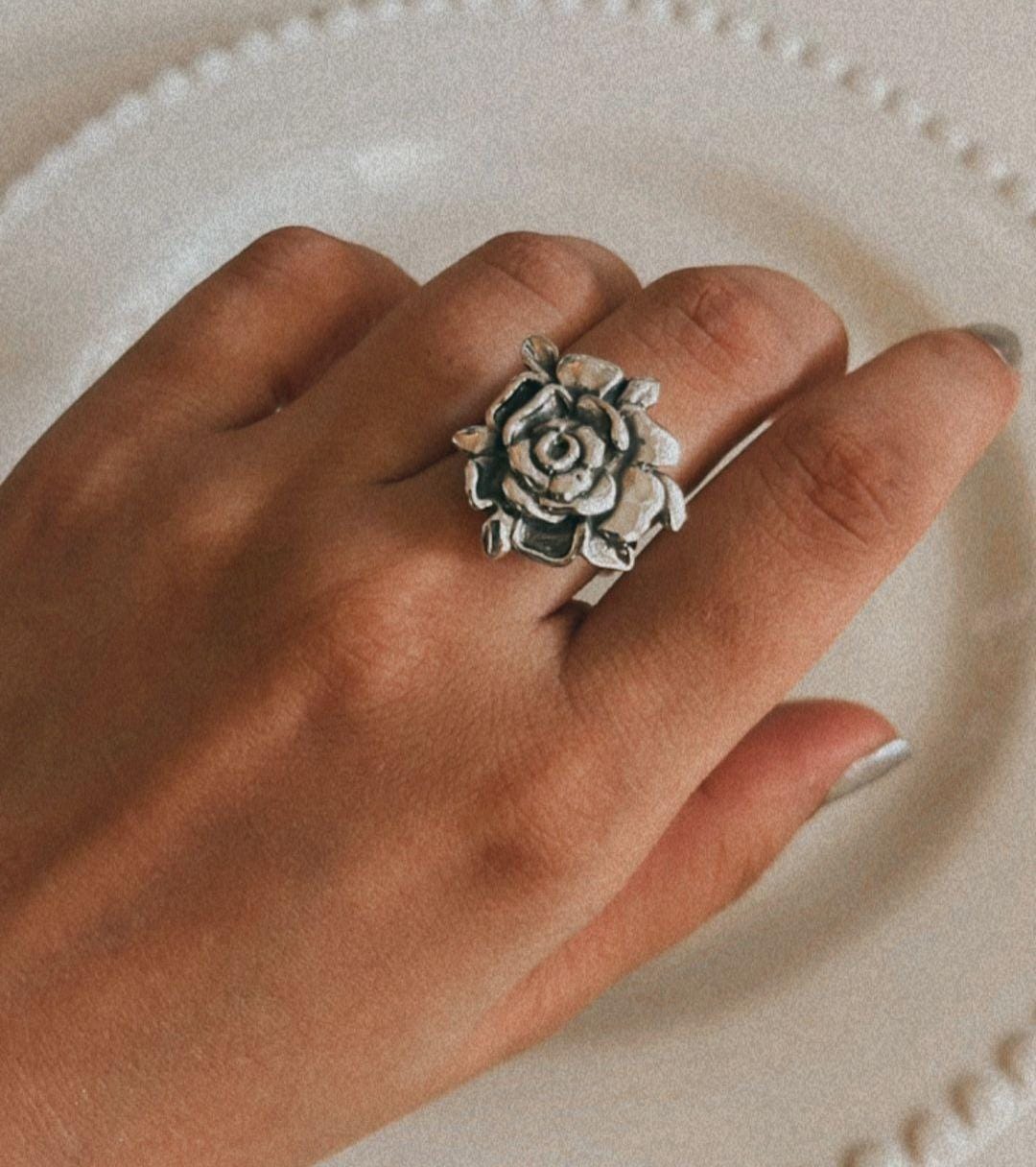 Chunky silver ring with a smooth finish and rose embellishment