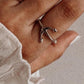 Nautical-inspired silver ring with an anchor emblem.