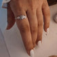 Handcrafted silver ring featuring a small feather