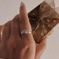 Handcrafted boho-style silver ring featuring a round rose quartz
