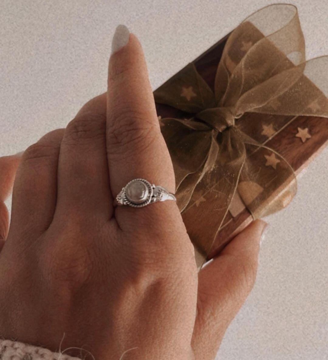 Handcrafted boho-style silver ring featuring a round rose quartz