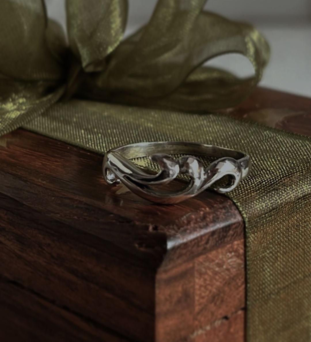 Sleek silver ring with wave-inspired design