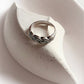Bold silver ring featuring a thick braided design