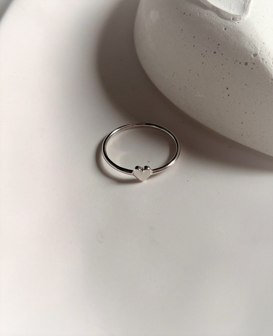 Sleek silver ring with subtle heart detail
