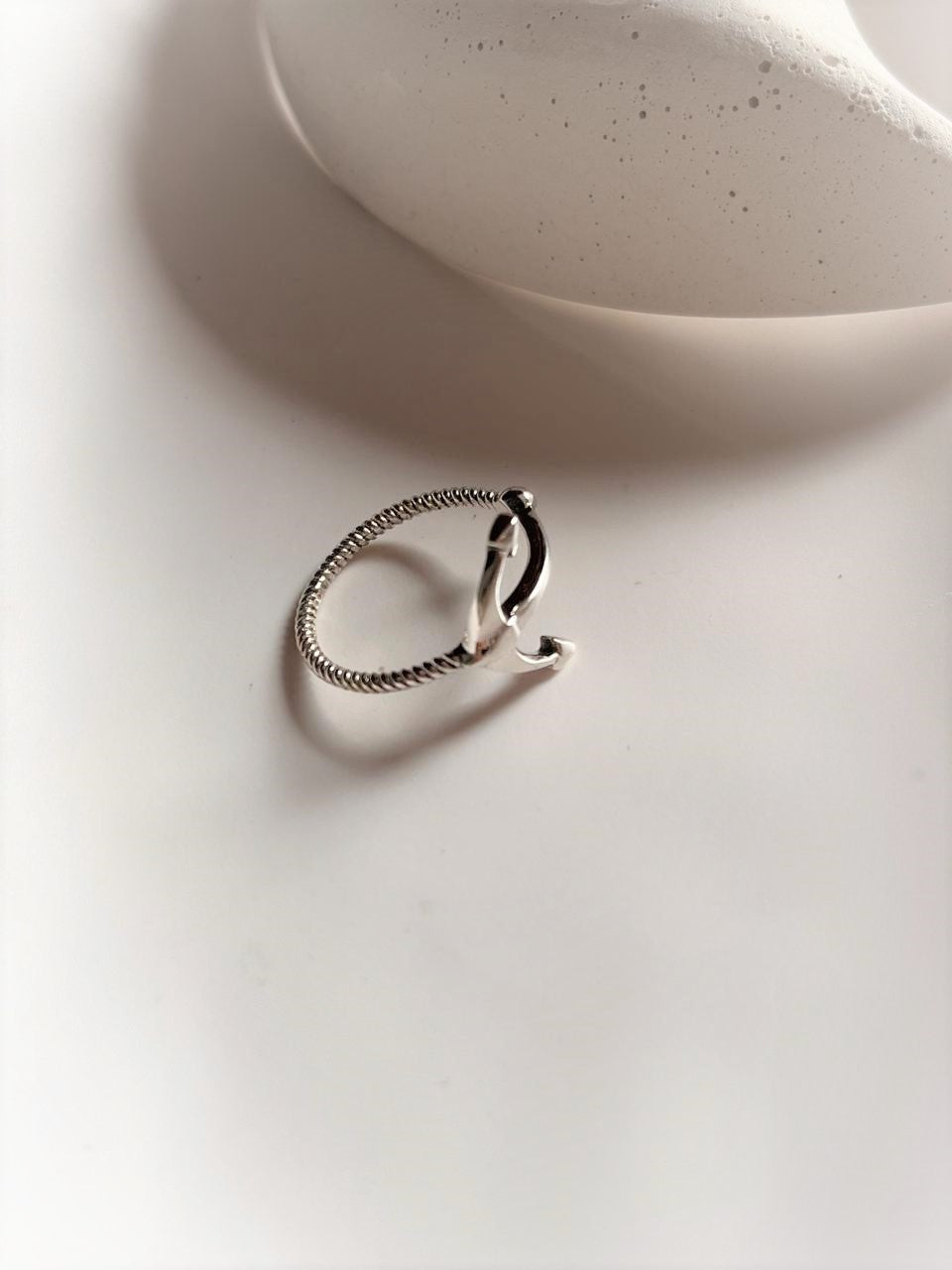 Sleek sterling silver ring featuring a minimalist anchor design.