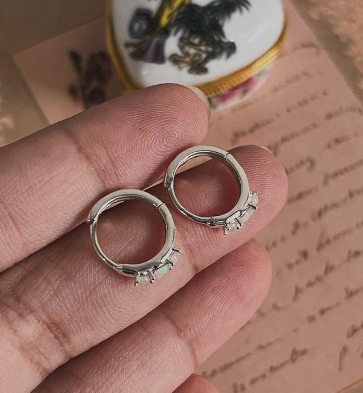 Delicate silver huggie earrings featuring opal gemstone