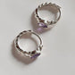 Handcrafted silver huggies featuring amethyst gemstone