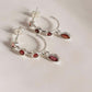 Silver half hoop earrings with garnet gemstone accents