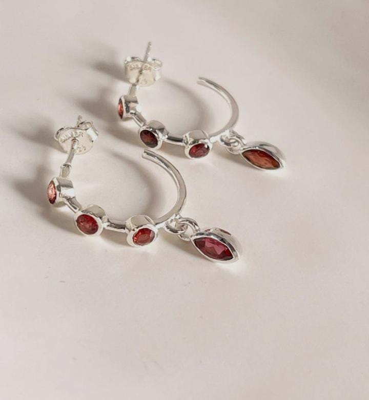Silver half hoop earrings with garnet gemstone accents