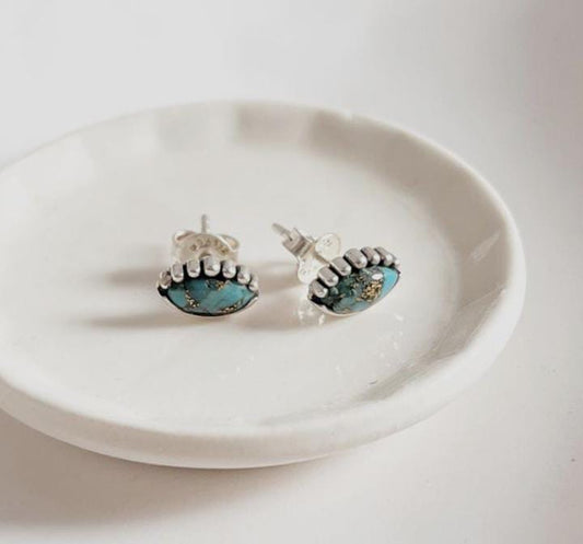 Elegant evil eye silver studs featuring copper and turquoise accents