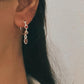 Sterling silver half hoop earrings featuring garnet stones