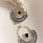 Close-up of Chandbali silver earrings featuring garnet stones