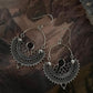 Elegant garnet gemstones set in intricate Chandbali silver earrings