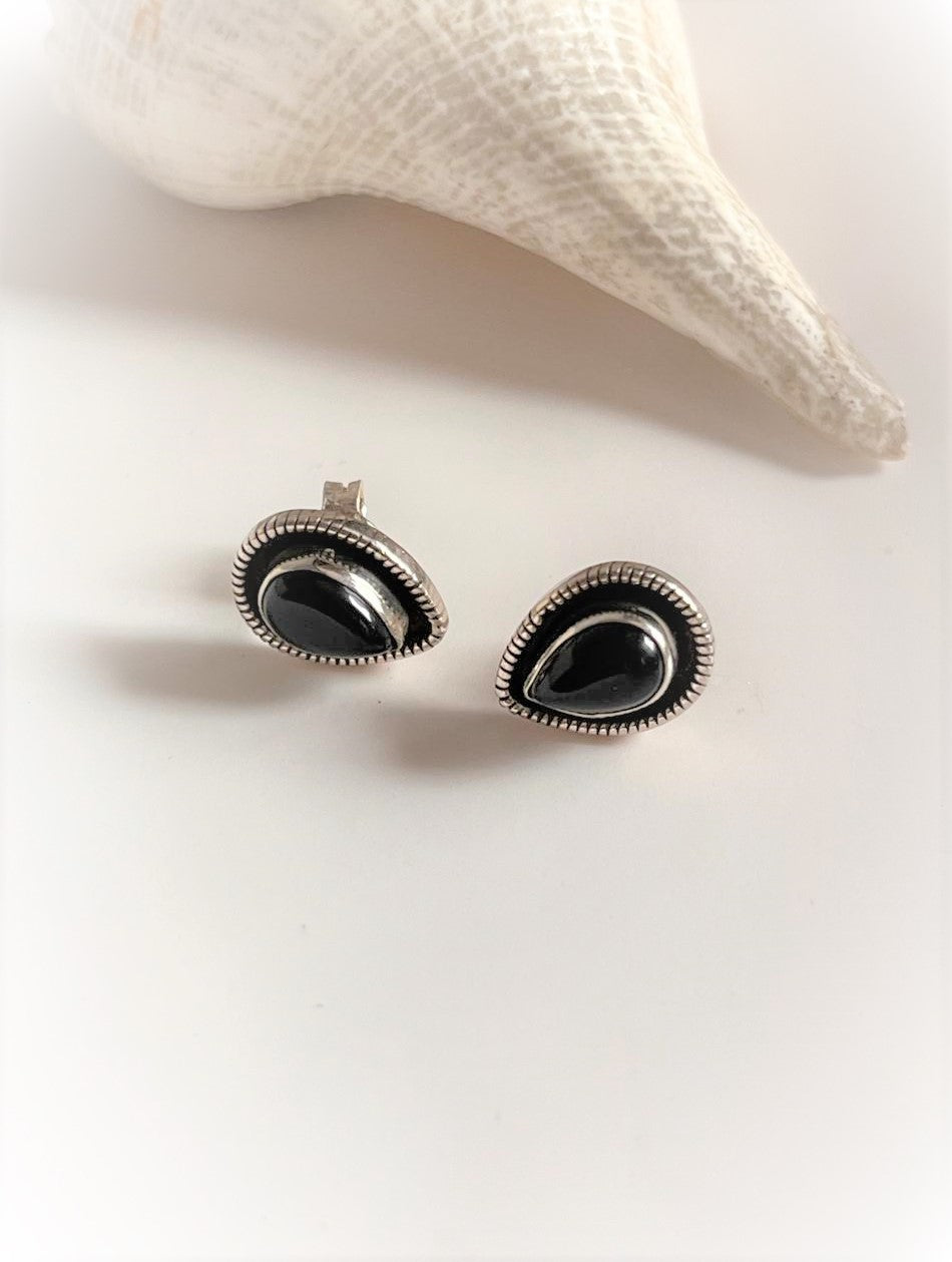 Chic black onyx pear-shaped studs in sterling silver for a unique look.