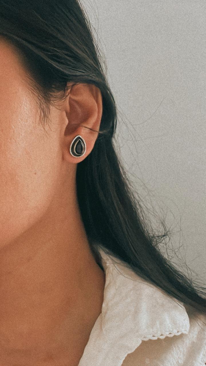 Sleek boho-style black onyx pear silver studs for a bold statement.