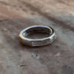 Close-up of clear quartz five stone silver ring with refined design