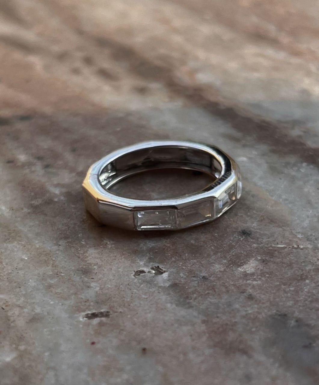 Close-up of clear quartz five stone silver ring with refined design