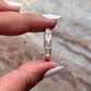Sleek silver ring with five clear quartz stones set in a row