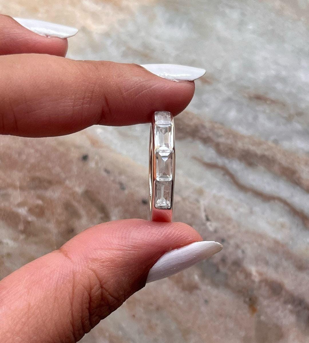 Sleek silver ring with five clear quartz stones set in a row