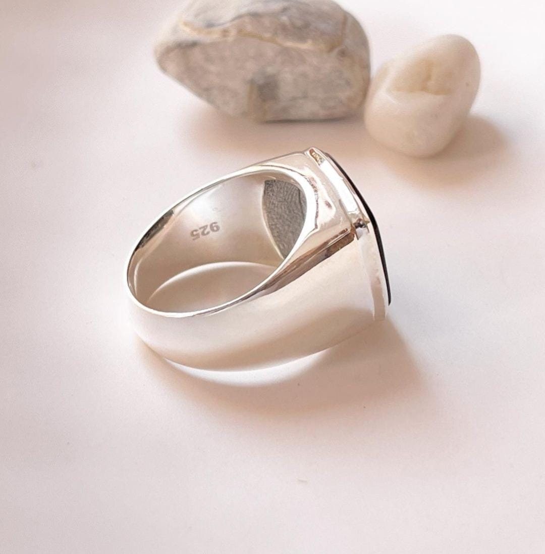Exquisite big faceted signet ring with a deep black onyx gemstone.