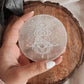 Healing selenite charging plate featuring Buddha symbol