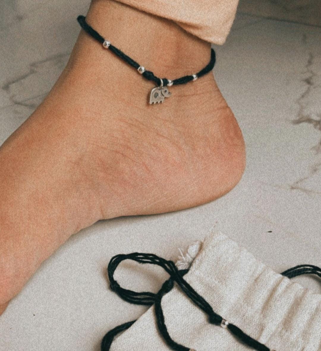 Close-up of cute hathi charm pendant on a silver Nazariya bracelet
