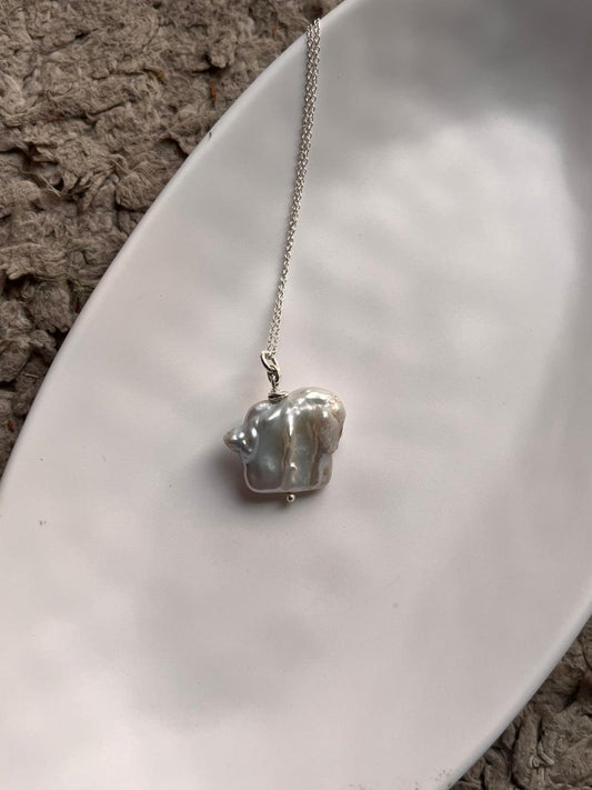 Elegant necklace with four Baroque pearls, each with a distinct and organic shape.