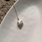 Timeless silver necklace featuring two Baroque pearls with organic shapes.