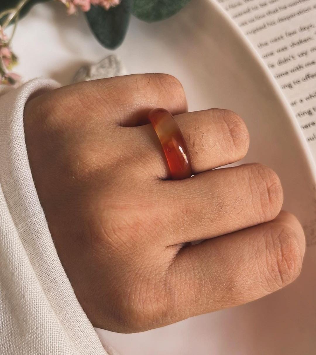 Close-up of carnelian crystal set in a silver band ring