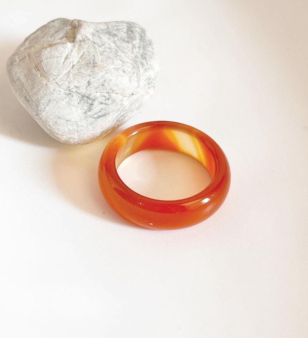 Handcrafted carnelian crystal band ring on a finger