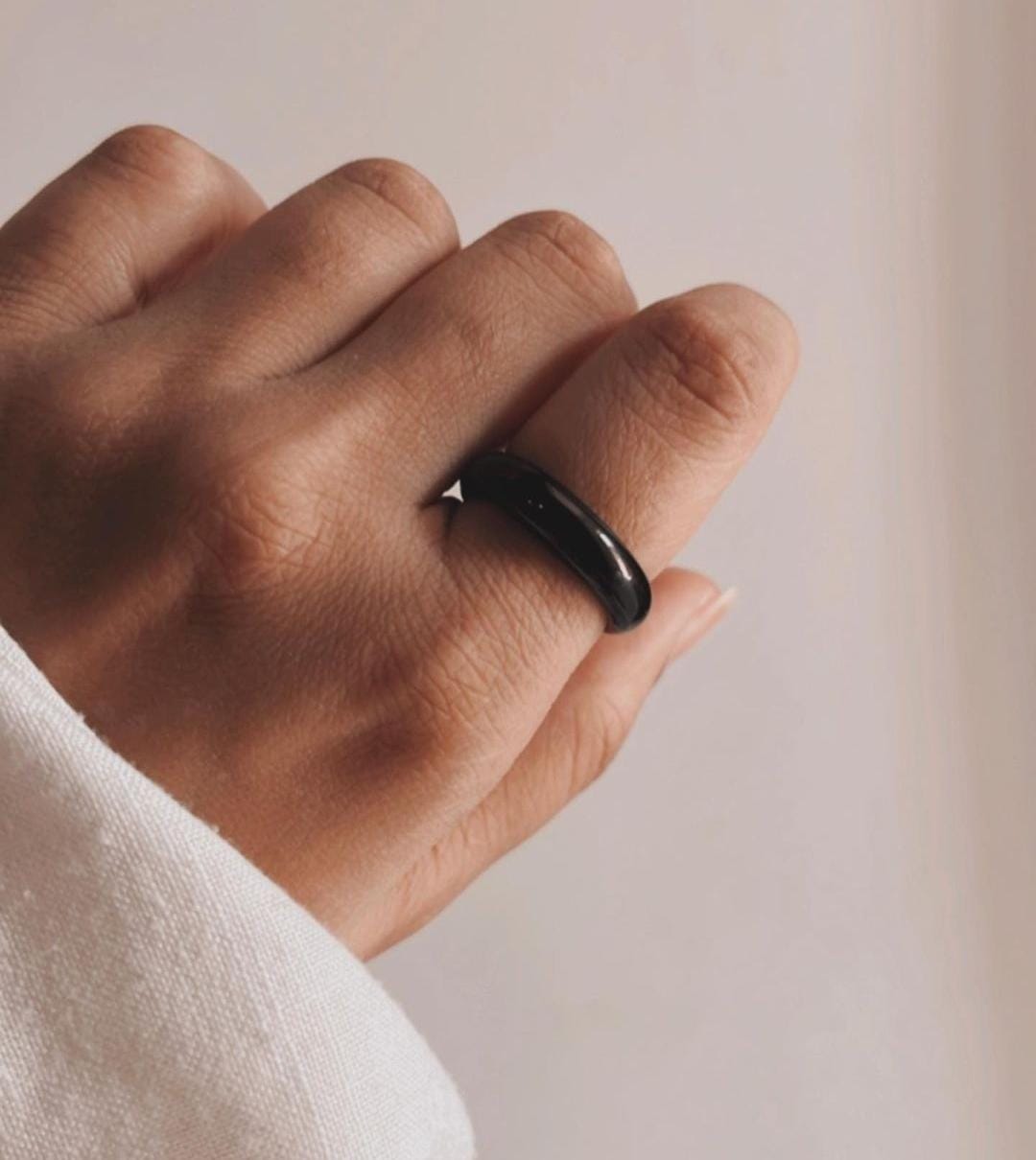 Handcrafted black agate crystal band ring with a smooth, modern look.