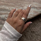 Close-up of chunky 3 rolling bands silver ring with smooth finish