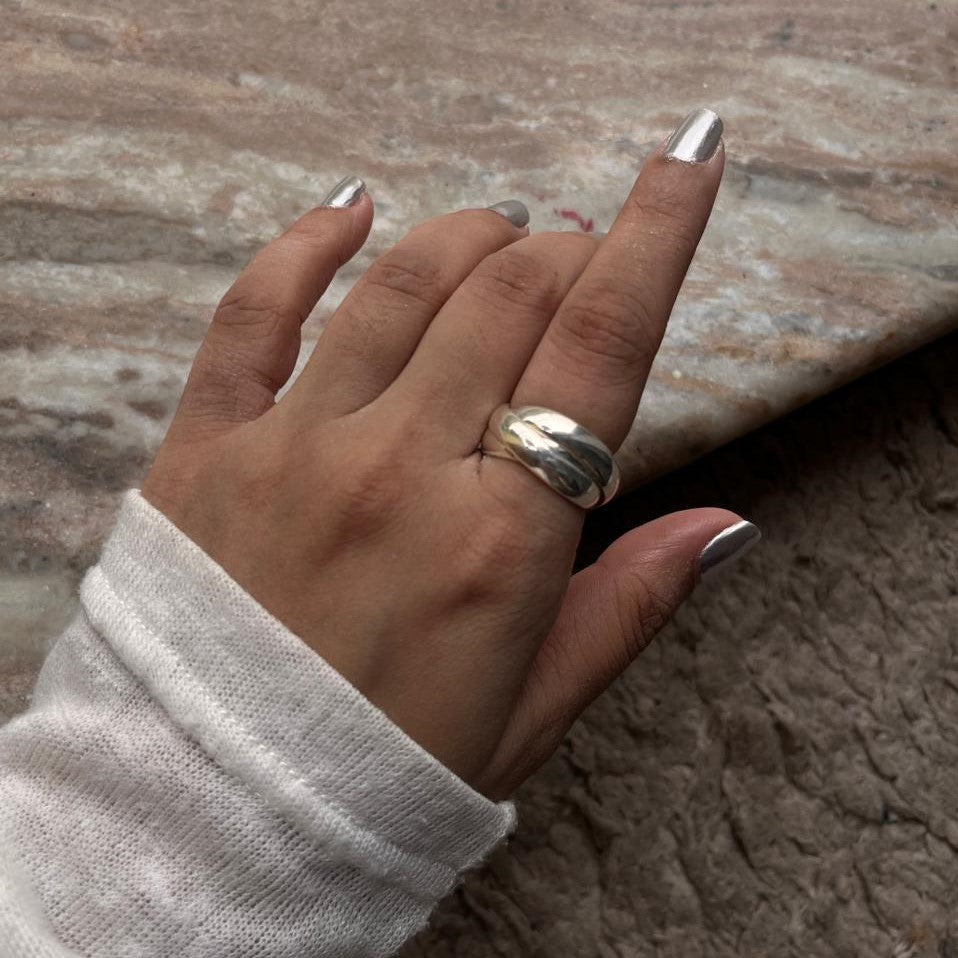 Close-up of chunky 3 rolling bands silver ring with smooth finish