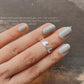 Sleek adjustable silver ring with wavy pattern