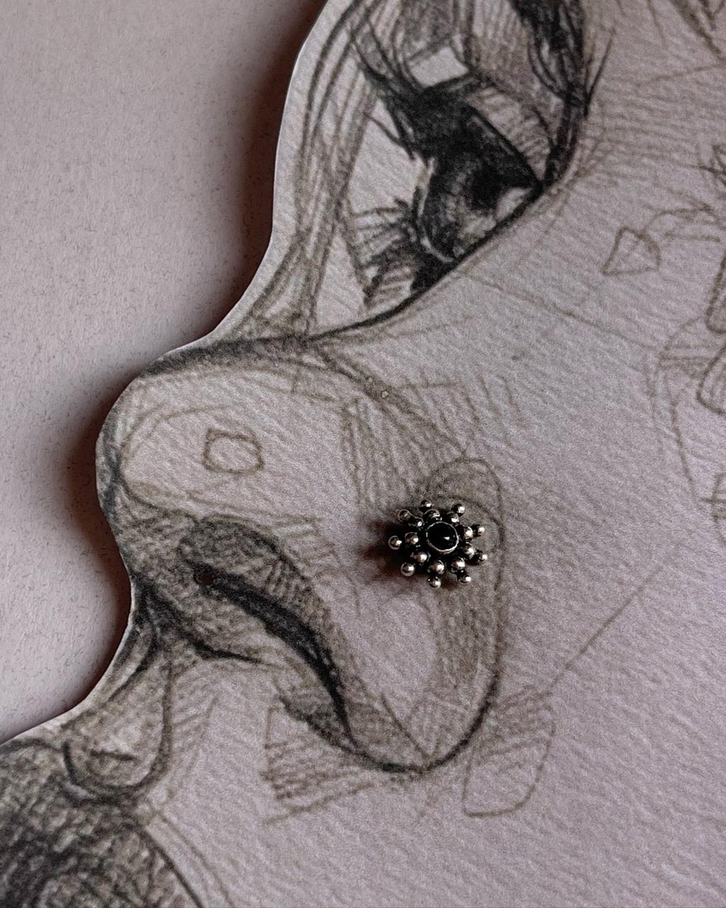 Close-up of Tribal Rawa black onyx mandala nose pin in 925 sterling silver