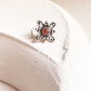 Elegant pink CZ nose pin with tribal rawa design and wired back for secure fit