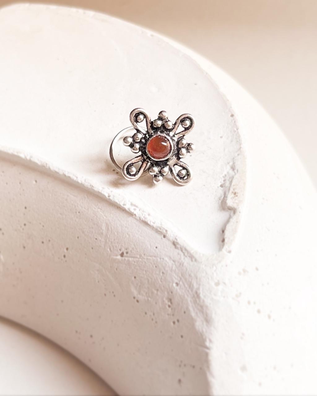 Elegant pink CZ nose pin with tribal rawa design and wired back for secure fit