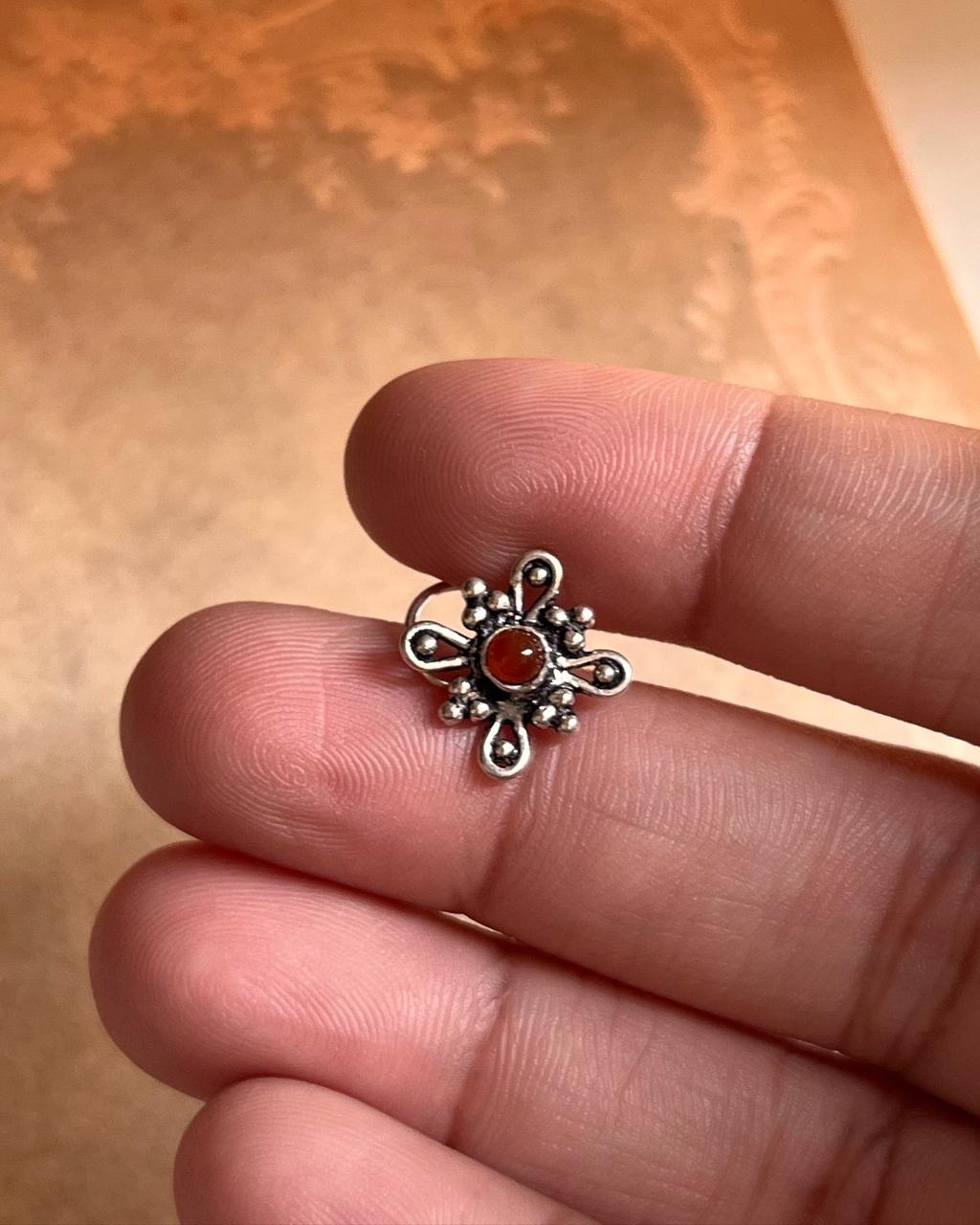 Tribal-inspired silver nose pin featuring pink CZ stone and wired back design