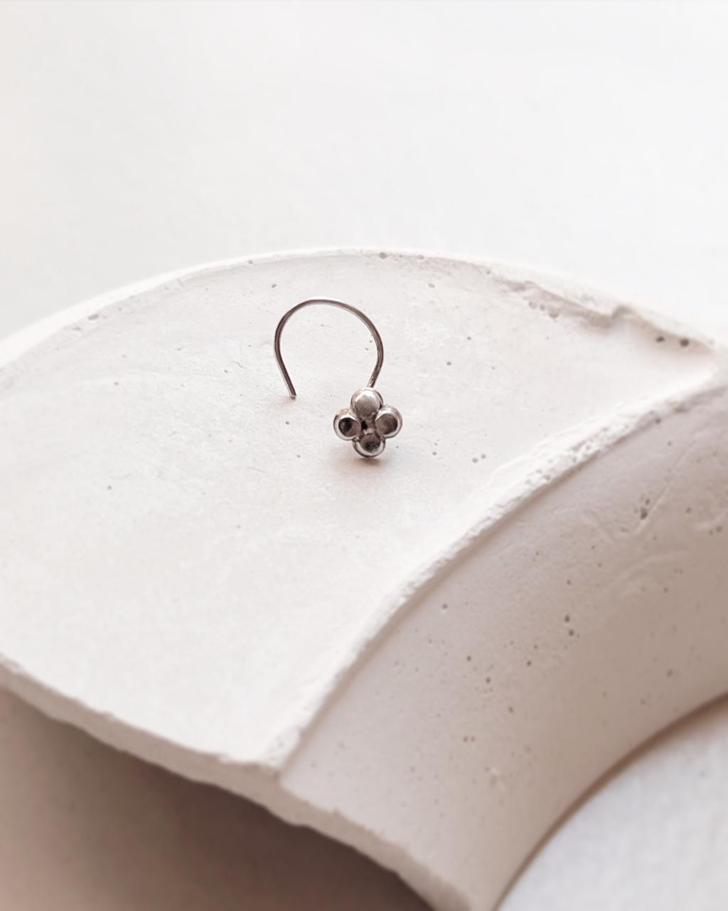 Tribal-inspired silver nose pin featuring flower design with wired back