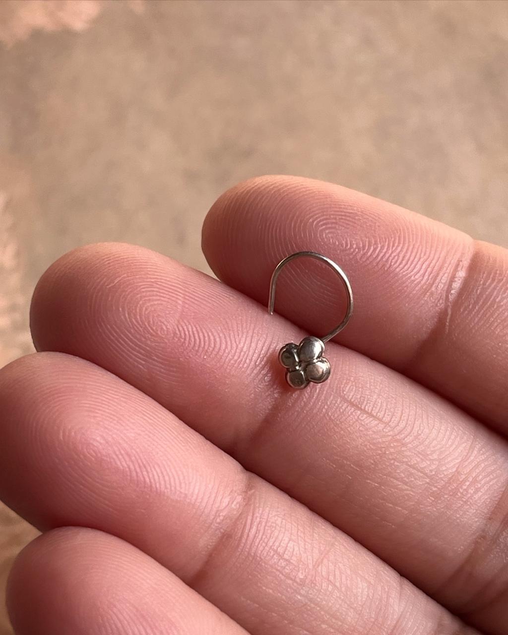 Elegant flower-shaped silver nose pin with tribal rawa design and wired back