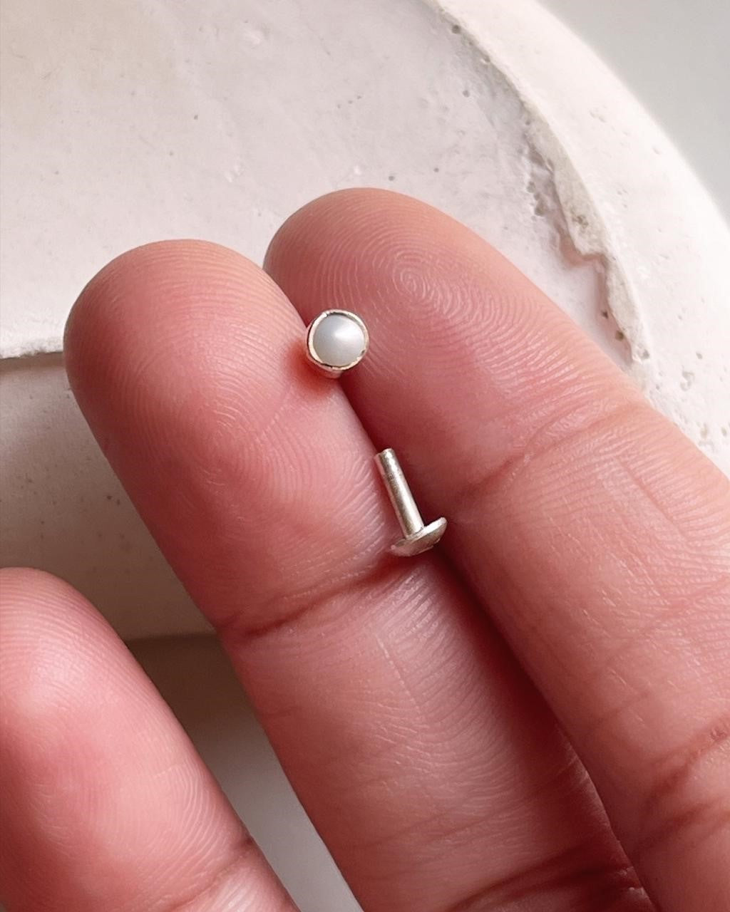 Close-up of pearl nose pin in 925 sterling silver with screw back