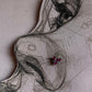 Close-up of handcrafted silver nose pin with pink cubic zirconia