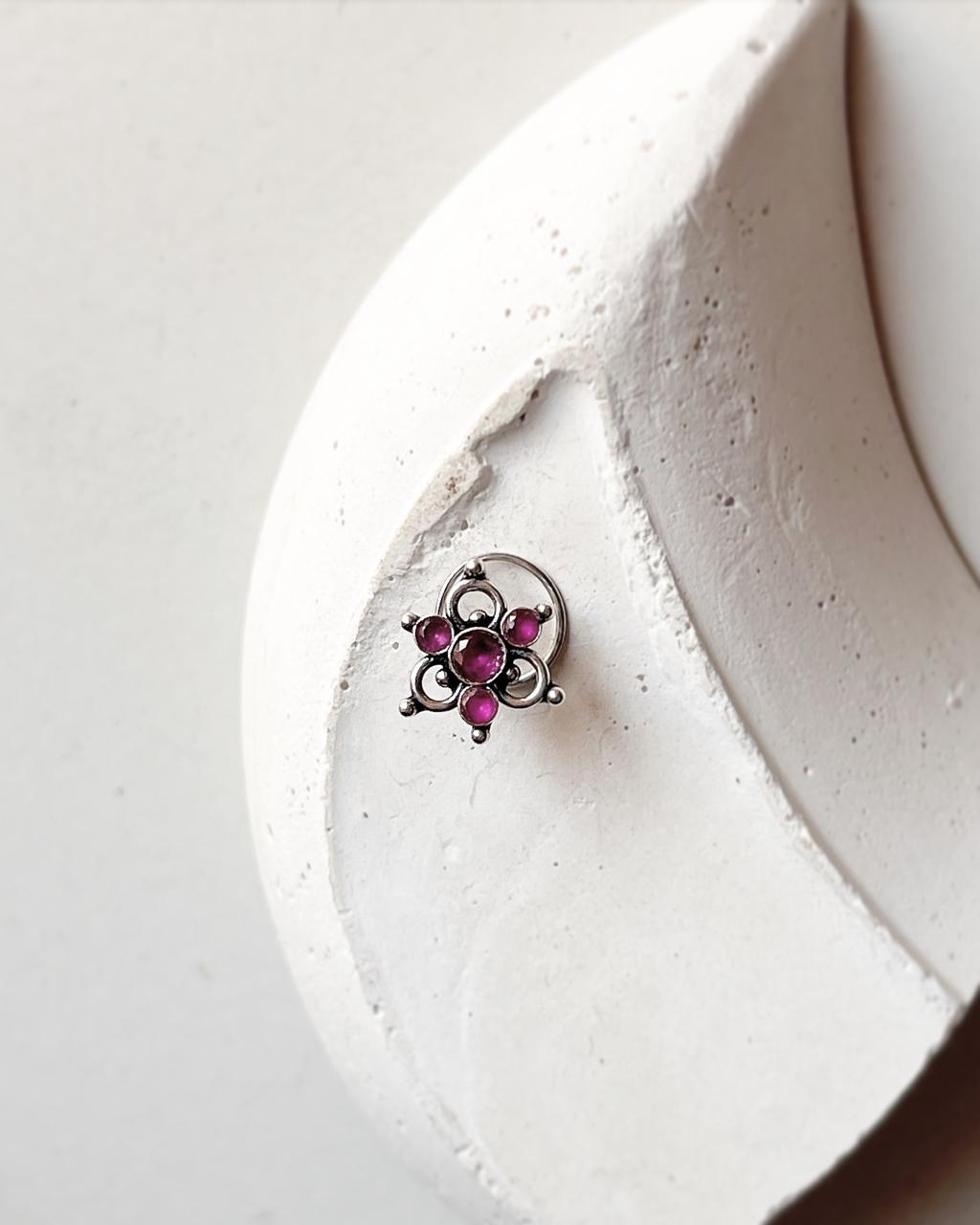Handcrafted silver nose pin with pink cubic zirconia and floral tribal pattern